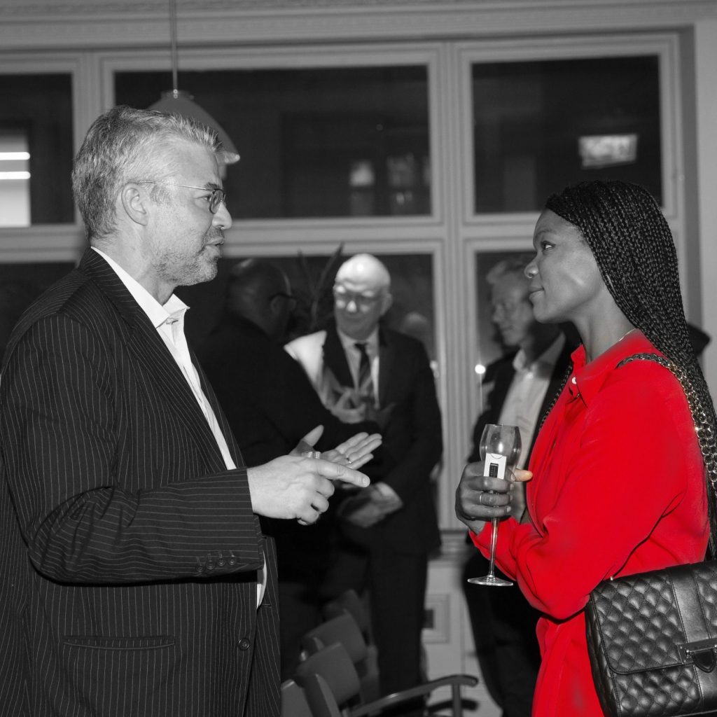partnership image red dress woman talking to man
